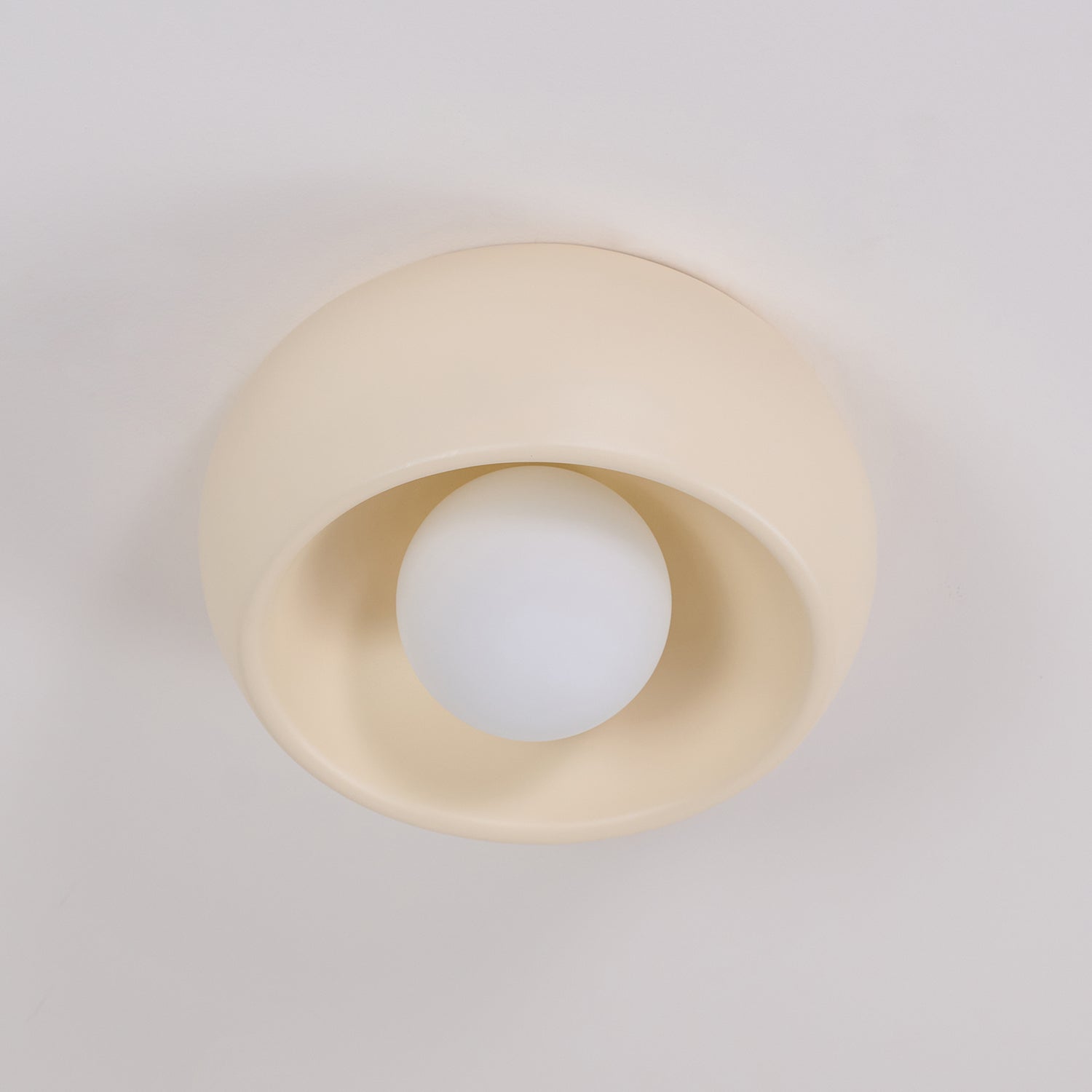 Beige ceiling light fixture on a white background