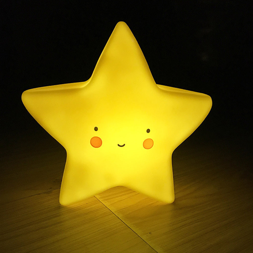 Star-shaped night light with a face on a wooden surface