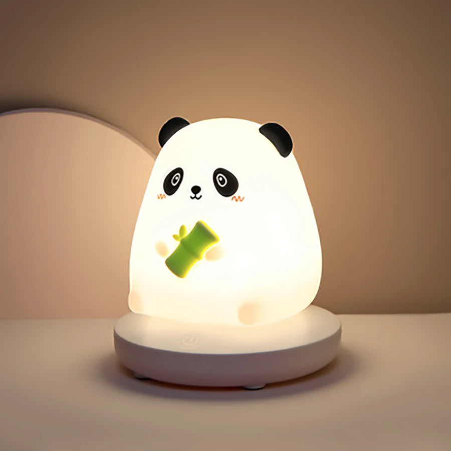 Panda-shaped night light with a green leaf on a beige background