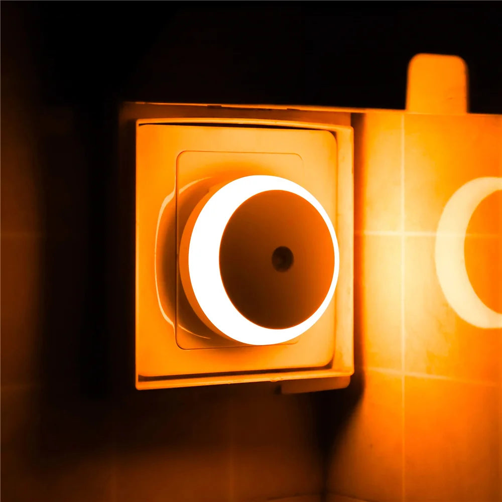 Orange night light switch on a dark background
