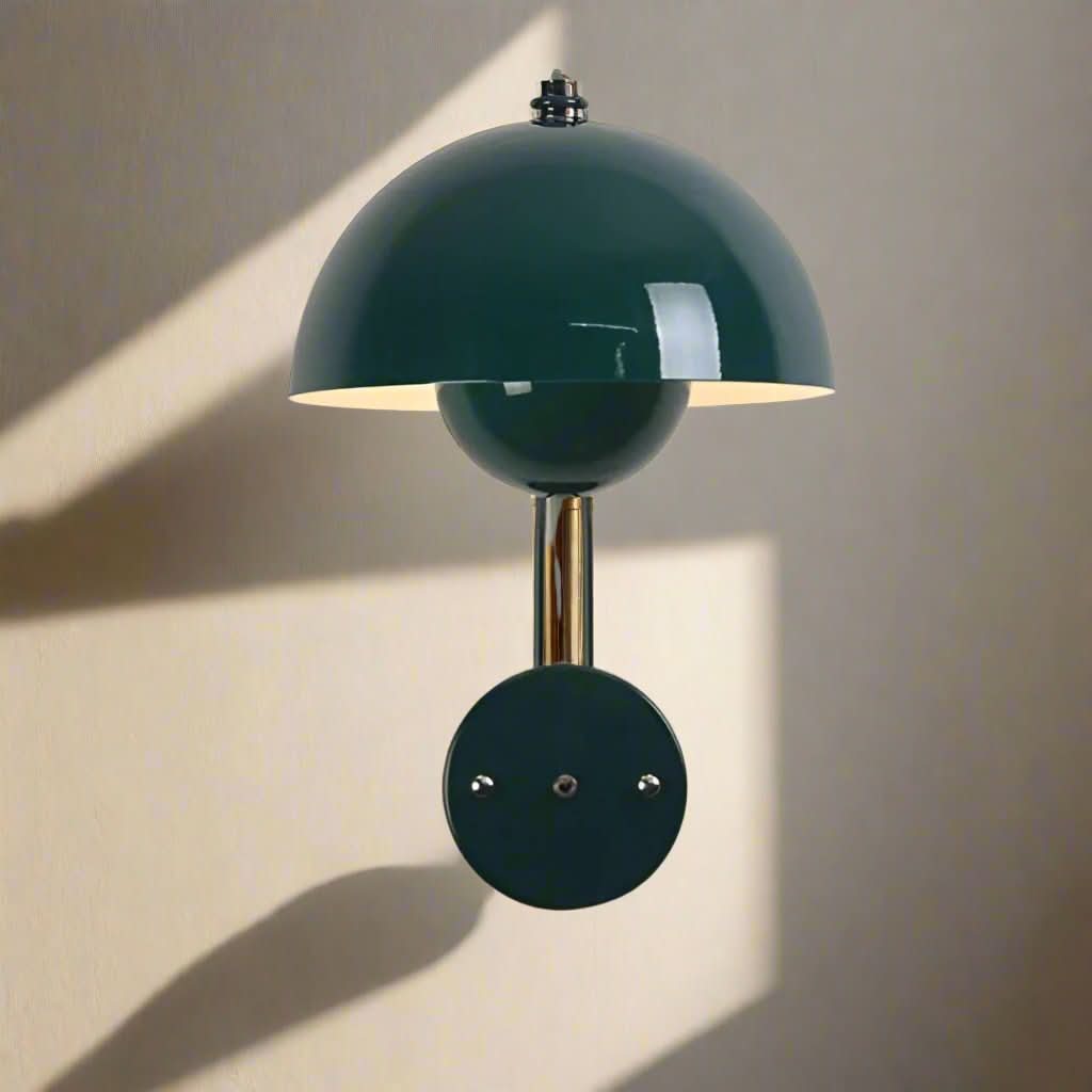 Modern wall lamp with green dome shade on a neutral background