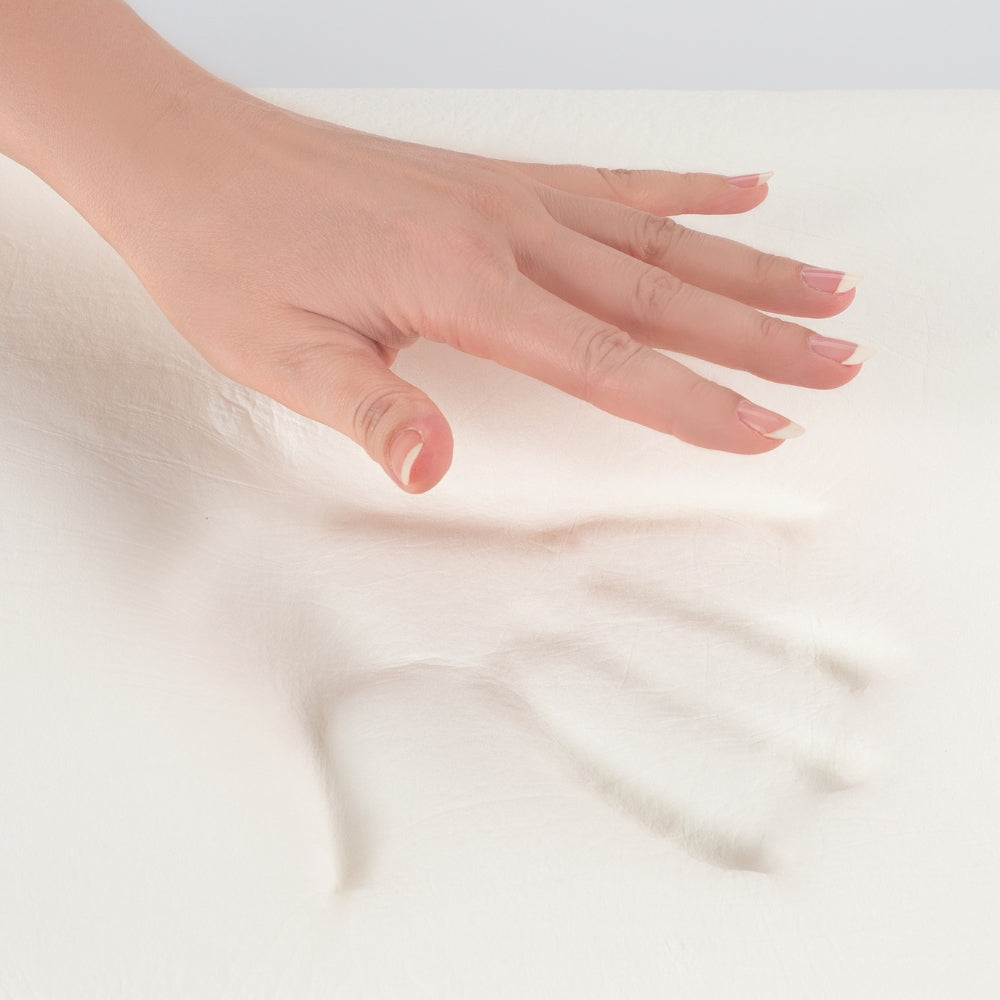 Hand resting on a soft, light-colored fabric surface