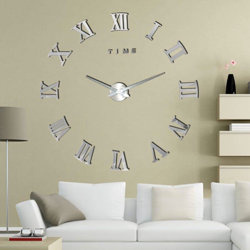 Large wall clock with Roman numeral design on a beige wall above a white sofa.
