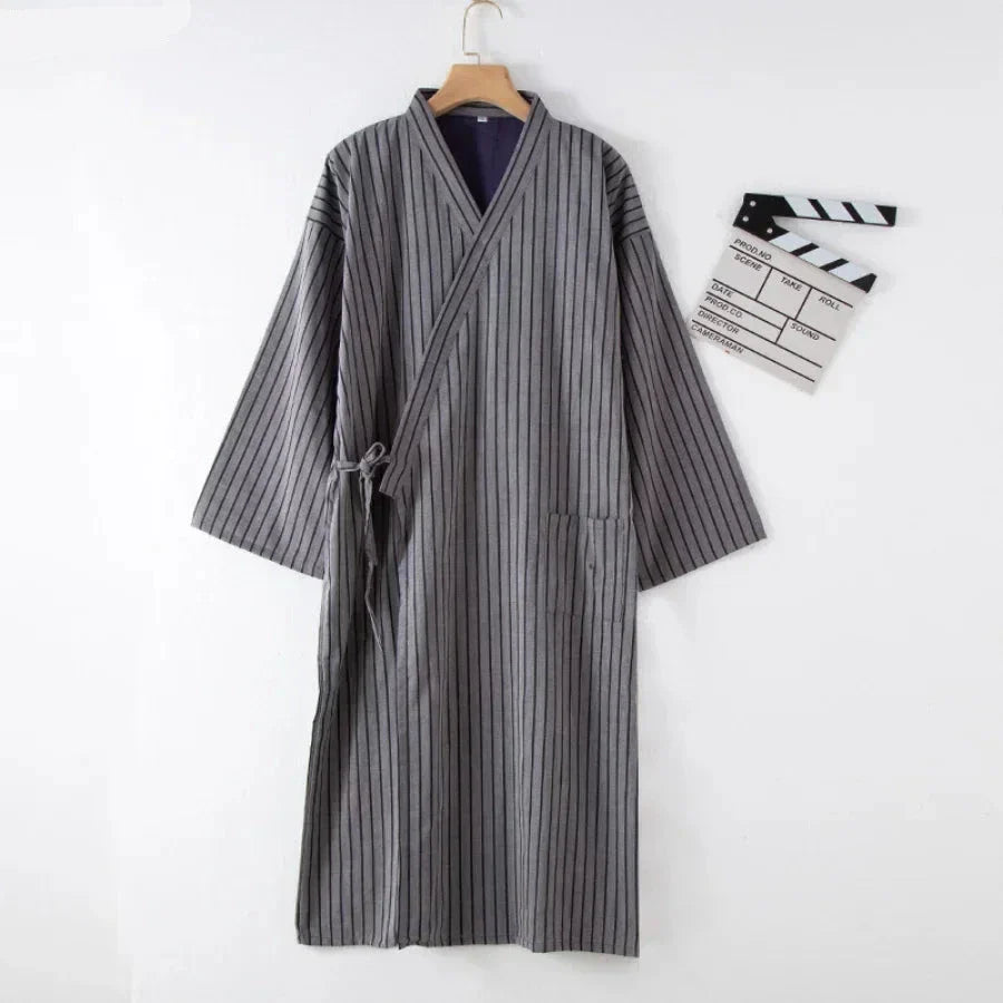 Gray striped robe on a hanger with a white background