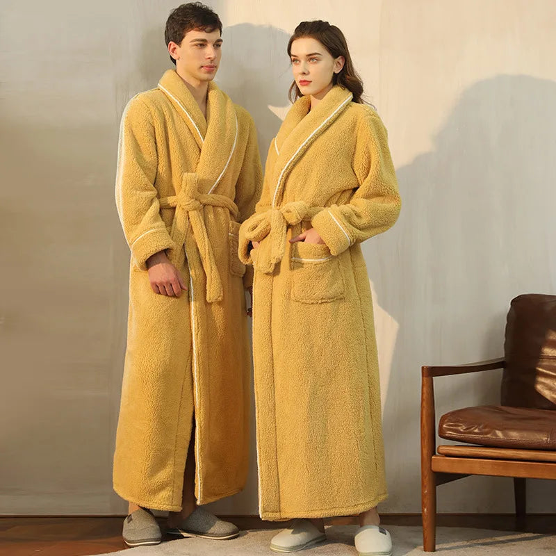 Two people wearing yellow robes standing in a room with a chair.