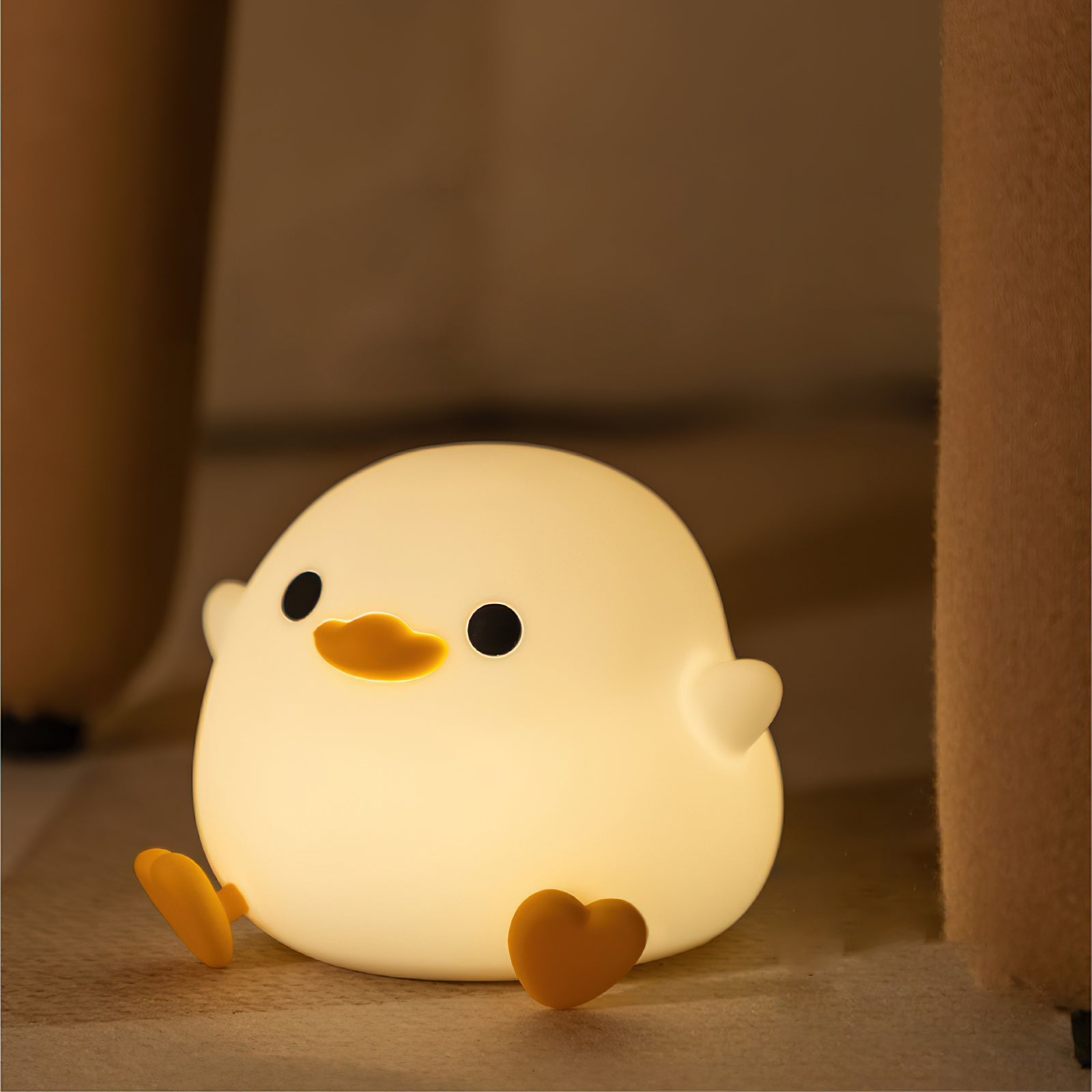 Cute chick-shaped night light on a soft brown background