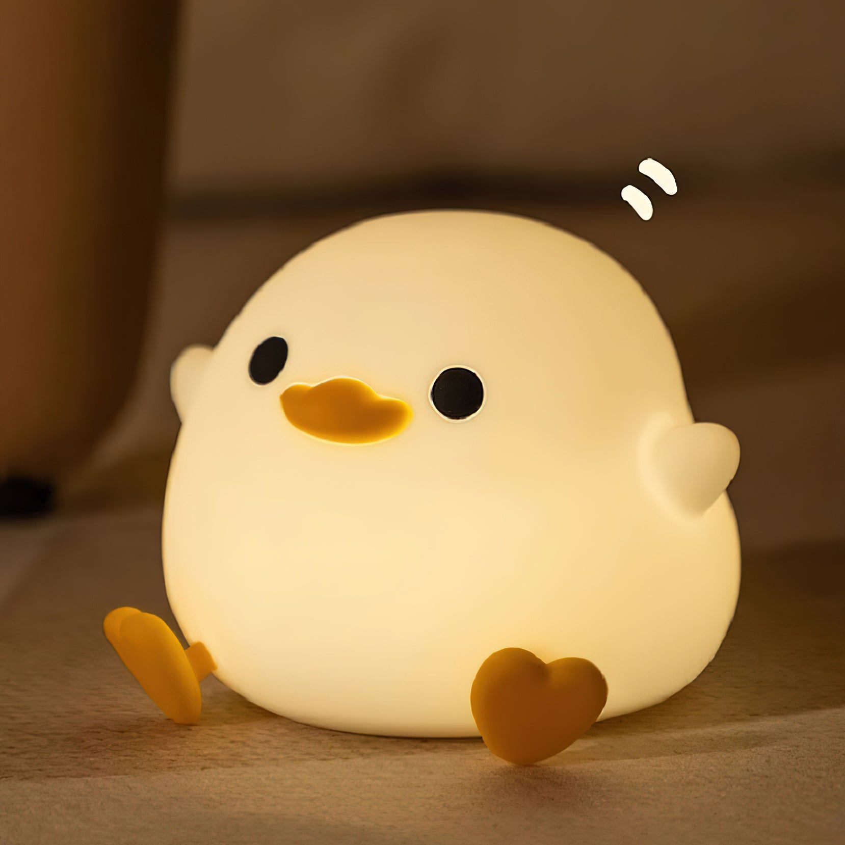 Cute chick-shaped night light on a soft brown background