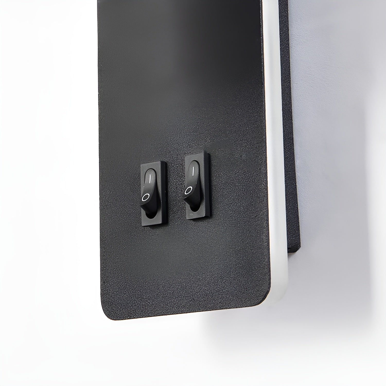 Black control panel with two switches on a white background