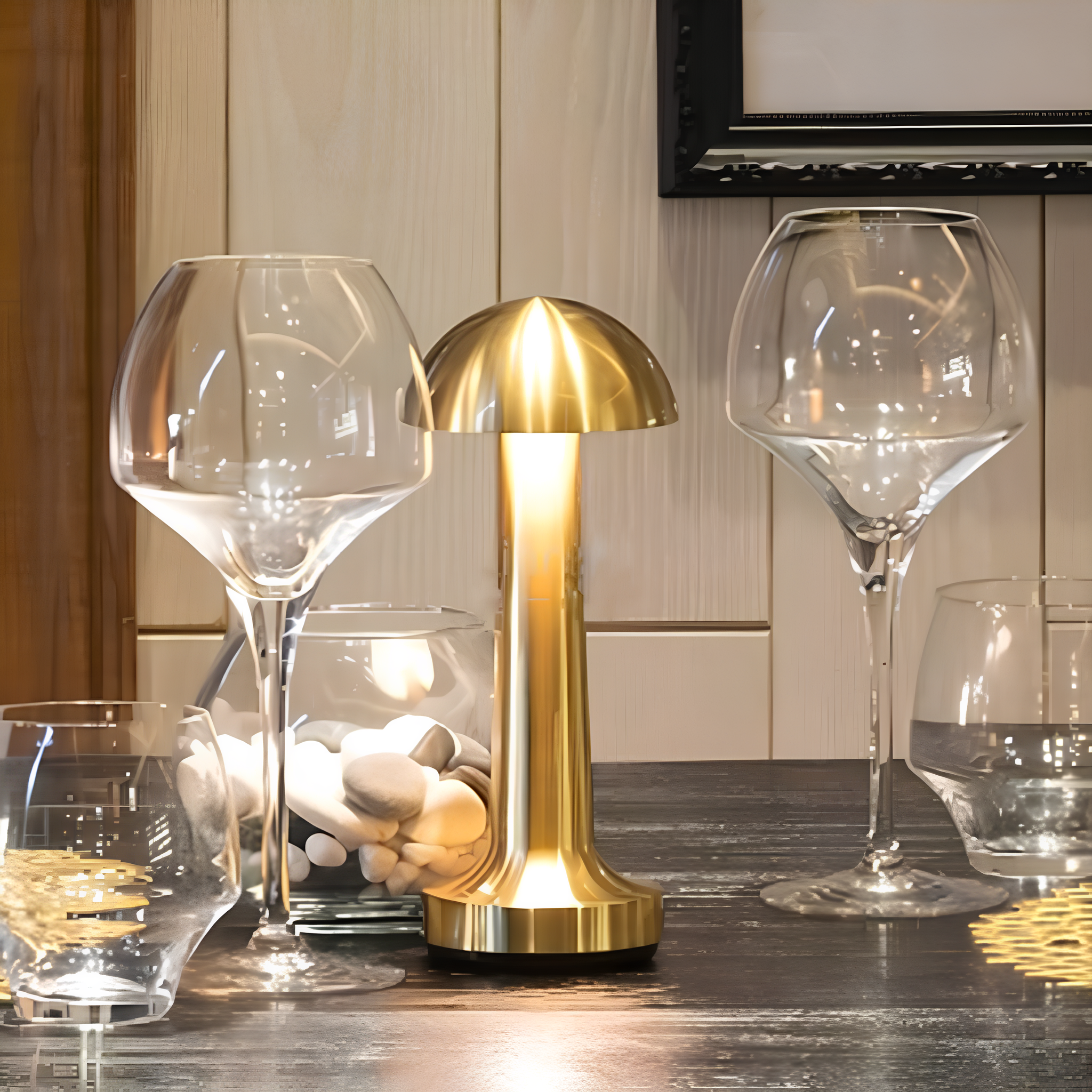 Gold mushroom lamp on a table with wine glasses and a candle