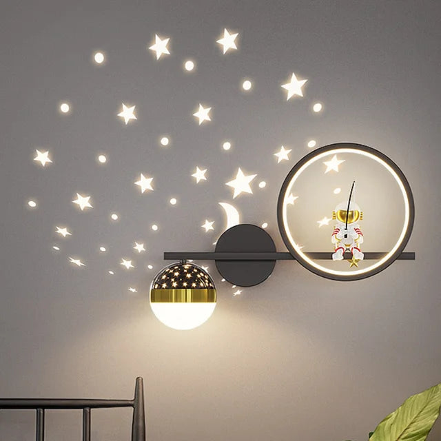 Decorative wall lights with star decals on a gray wall