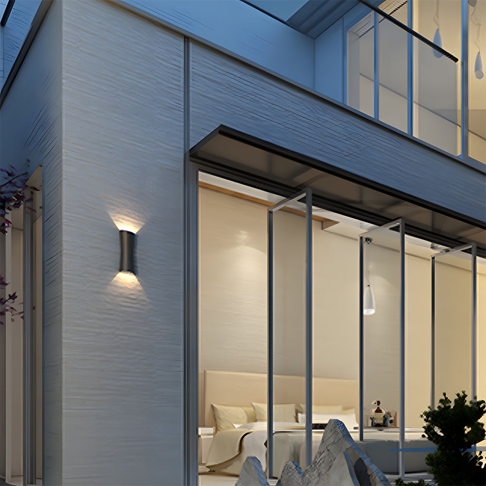 Modern building exterior with a wall-mounted light fixture and interior view.