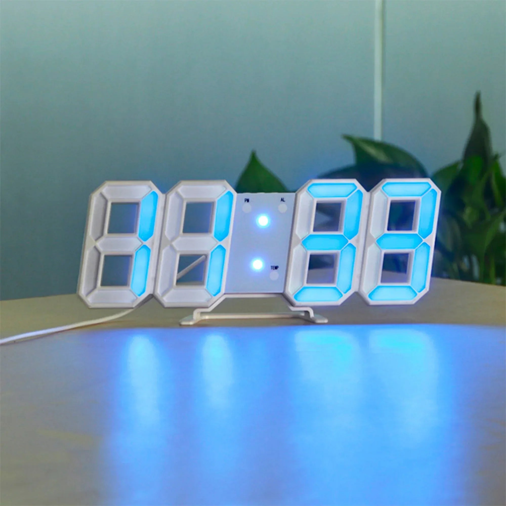 Digital clock with blue LED display on a light surface