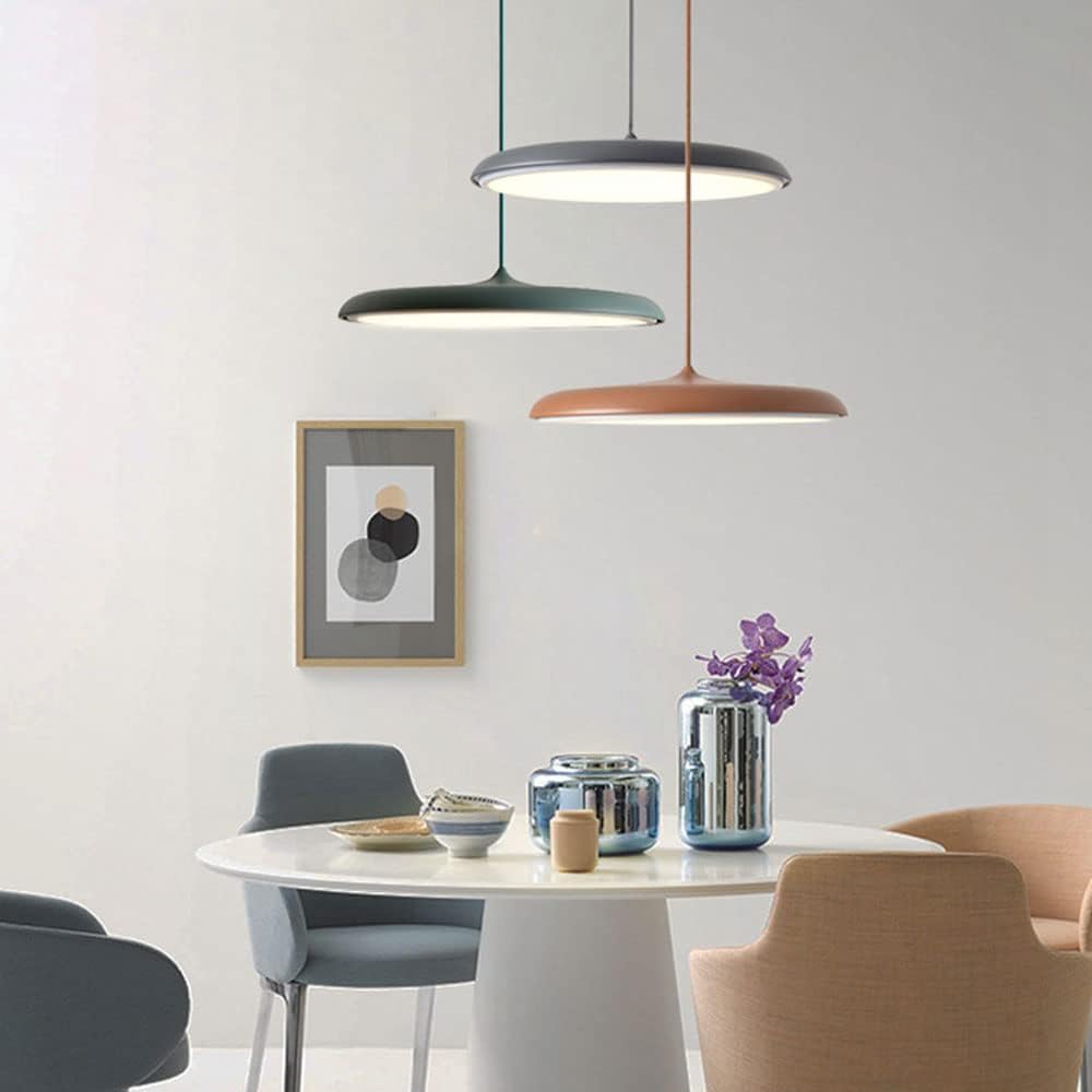 Modern dining area with pendant lights, table, chairs, and decorative items.