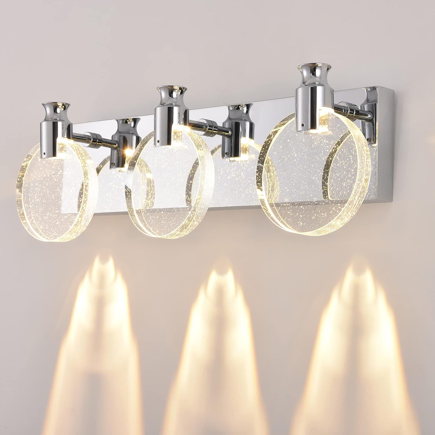 Modern bathroom light fixture with glass shades on a neutral background