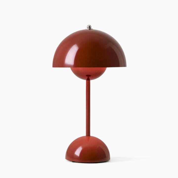 Red table lamp with a unique design on a white background