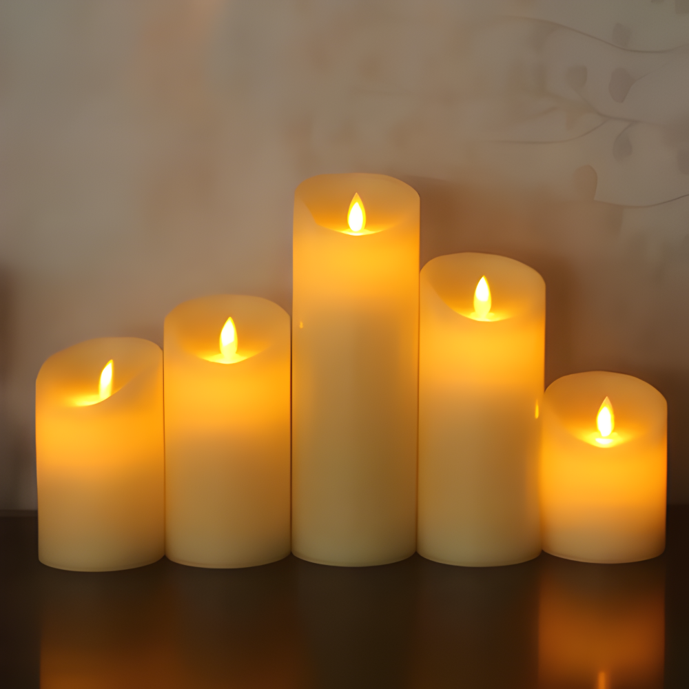 Set of five lit candles on a reflective surface with a neutral background