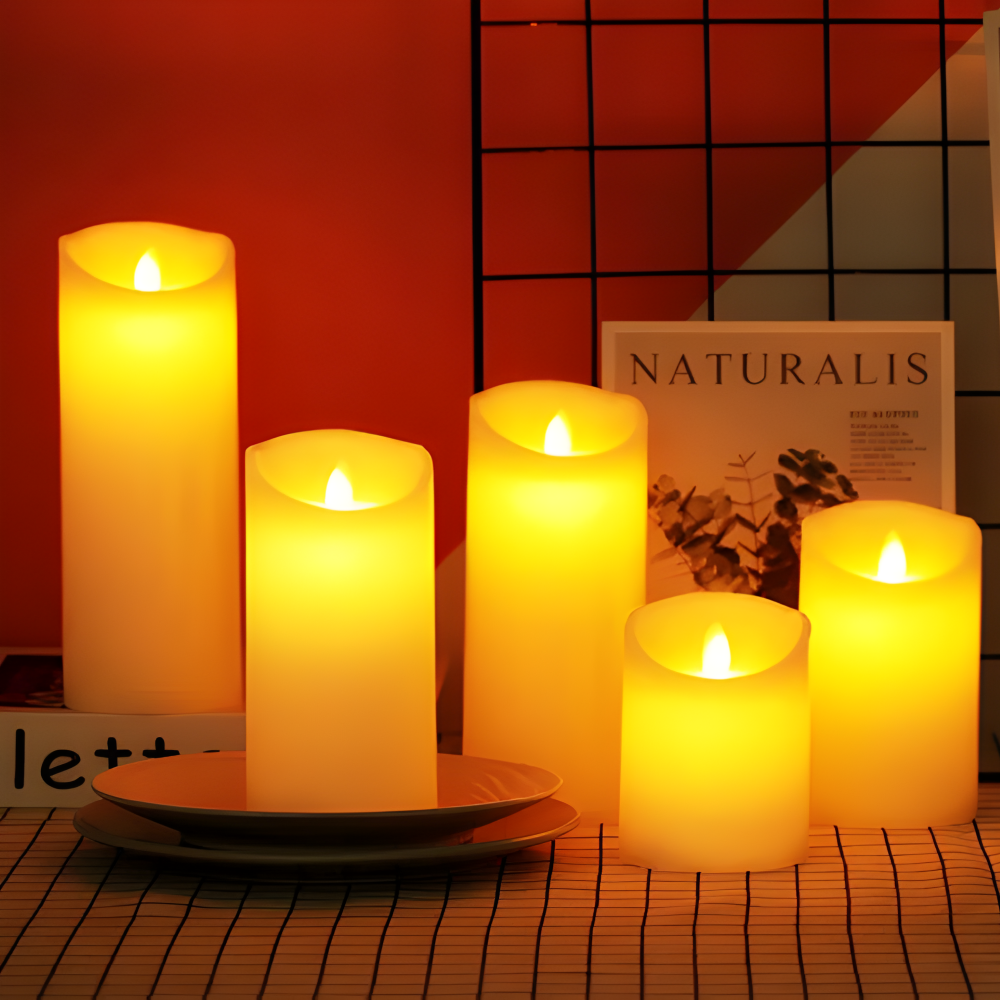 Set of lit candles on a table with a magazine in the background