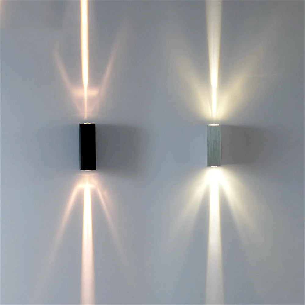 Two modern wall lights on a gray wall