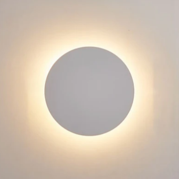 Round wall light fixture on a plain wall