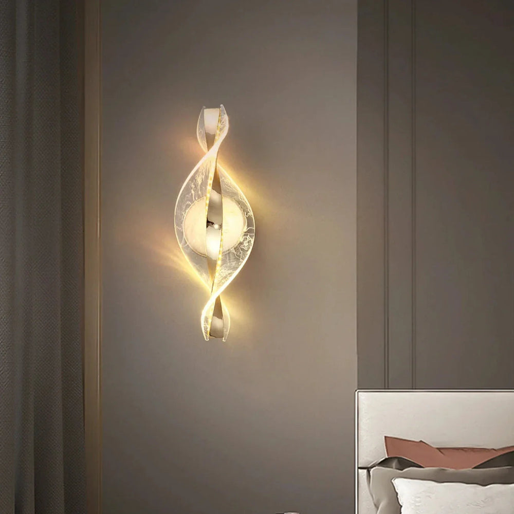 Decorative wall sconce on a gray wall with a bed in the background