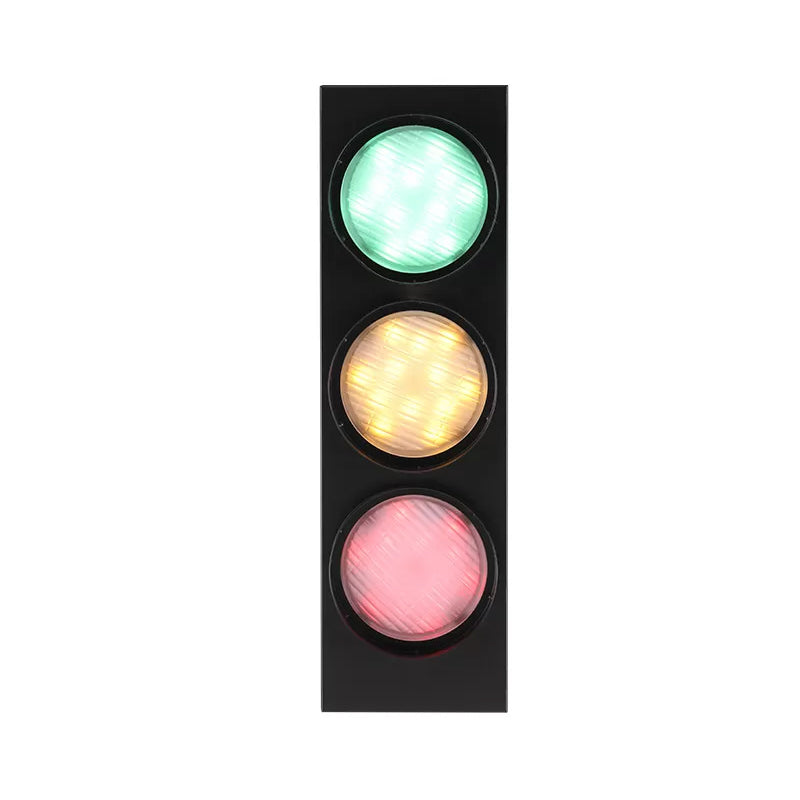Traffic light with green, yellow, and red lights on a white background