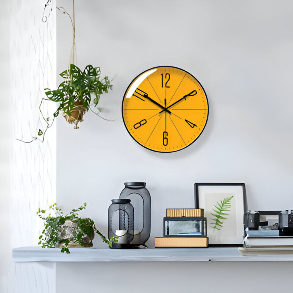 Yellow wall clock on a white wall with decorative items below