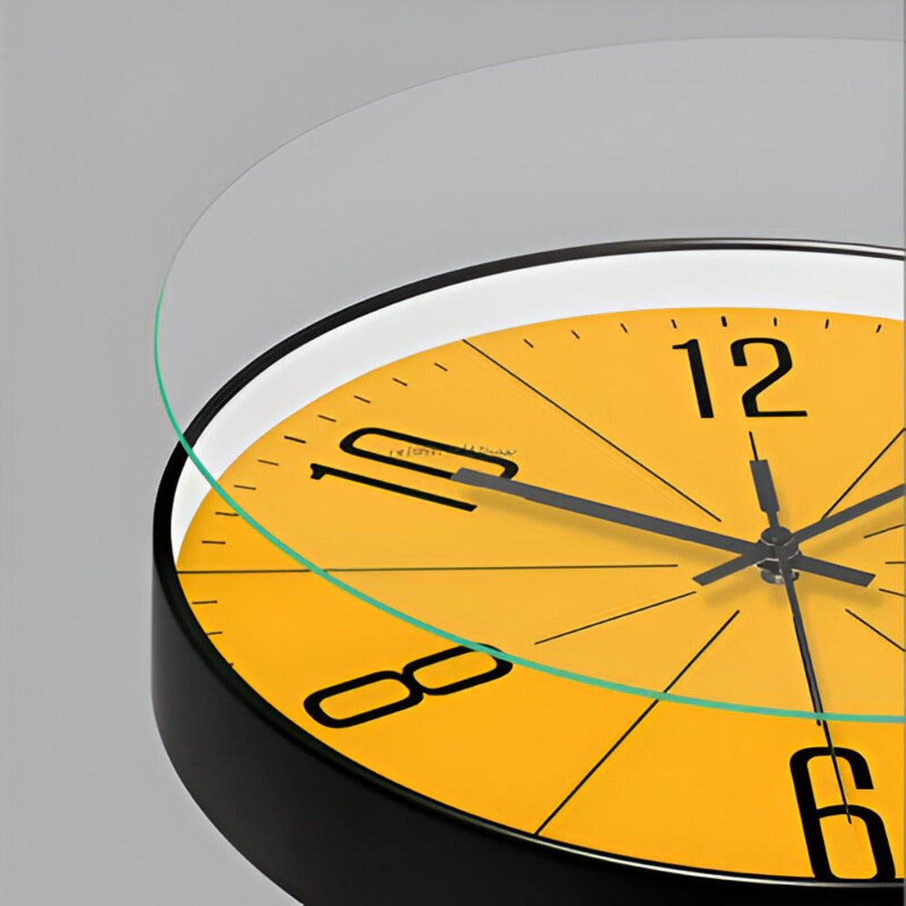 Yellow wall clock with black numbers and hands on a gray background