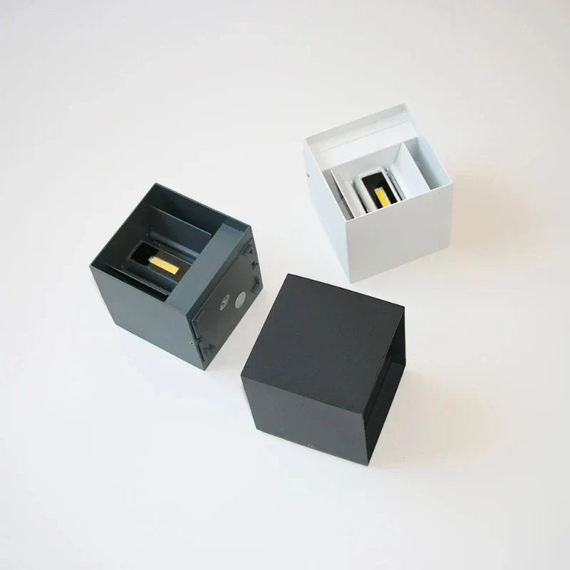 Three black and gray square boxes on a white background