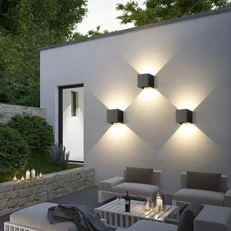 Modern outdoor setting with wall-mounted lights and a patio area.
