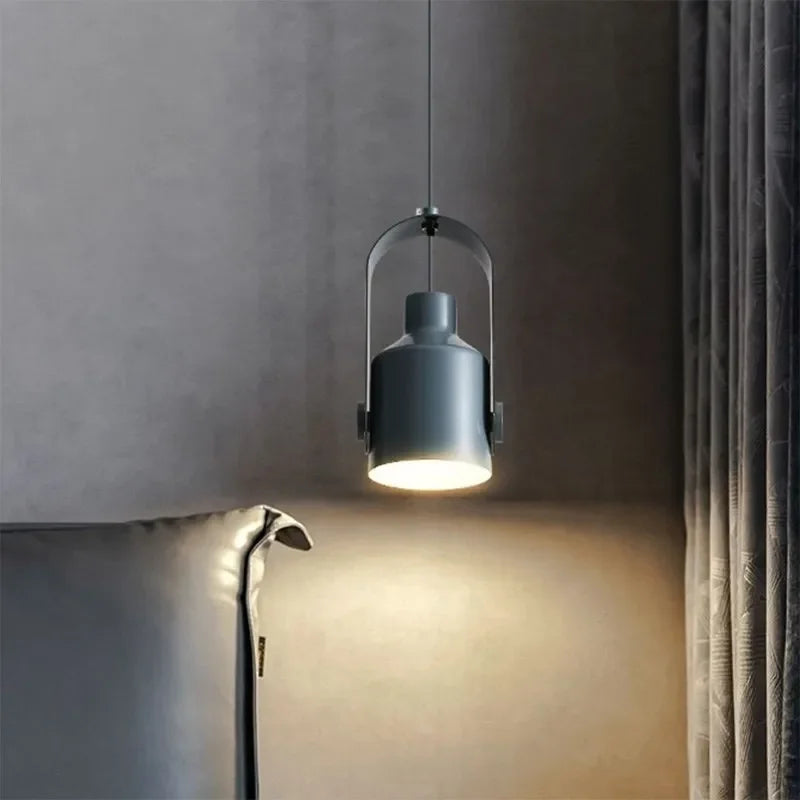 Modern pendant light fixture hanging against a neutral wall.