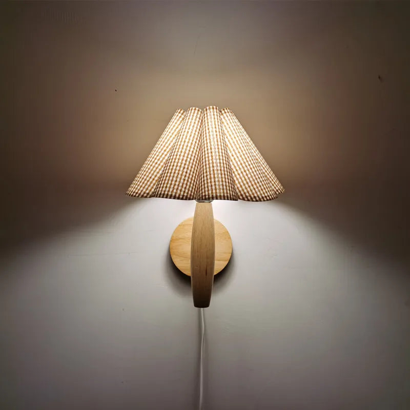 Wooden wall lamp with a textured shade on a plain wall