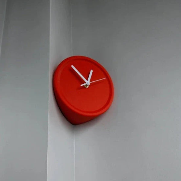 Red wall clock on a gray wall