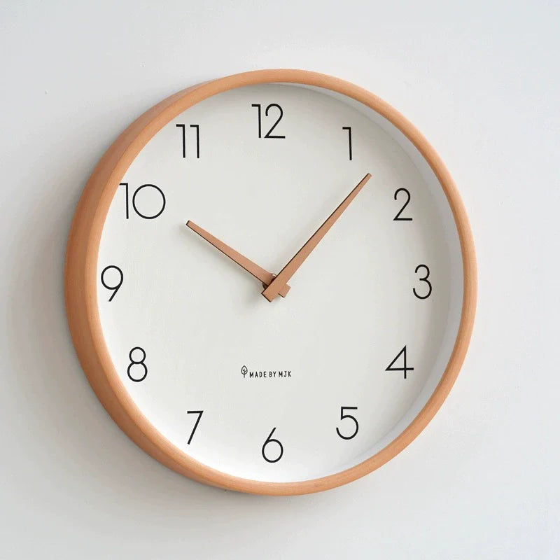 Wall clock with wooden frame and white face on a light gray background