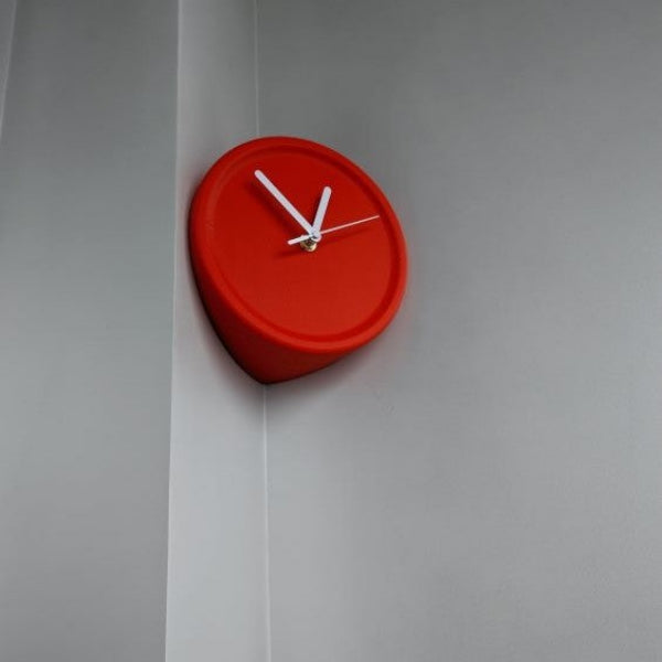 Red wall clock on a gray wall