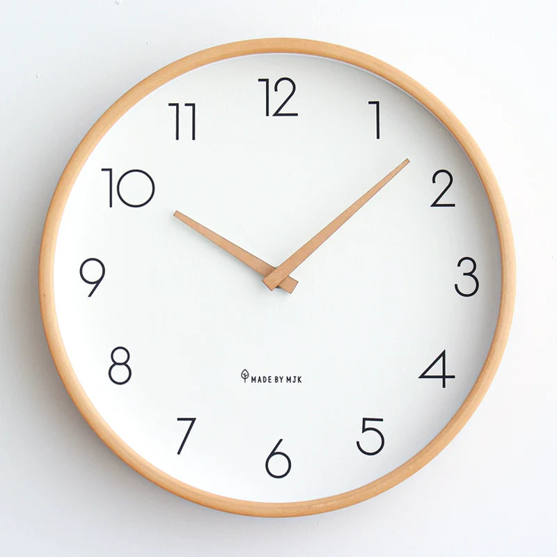 Wall clock with wooden frame and white face on a light gray background