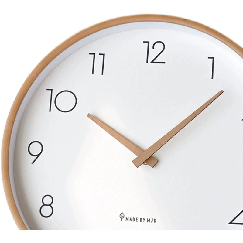 Wall clock with white face and wooden frame on a white background