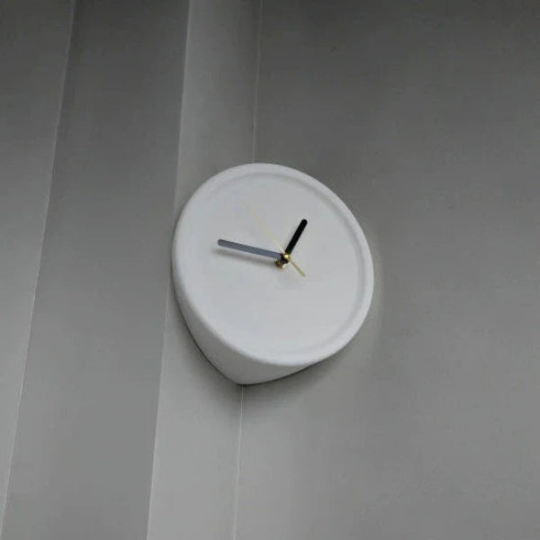 White wall clock on a gray wall