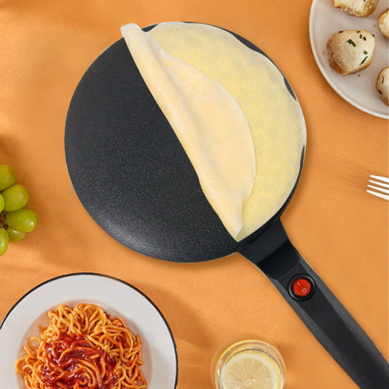 Black frying pan with food on an orange background