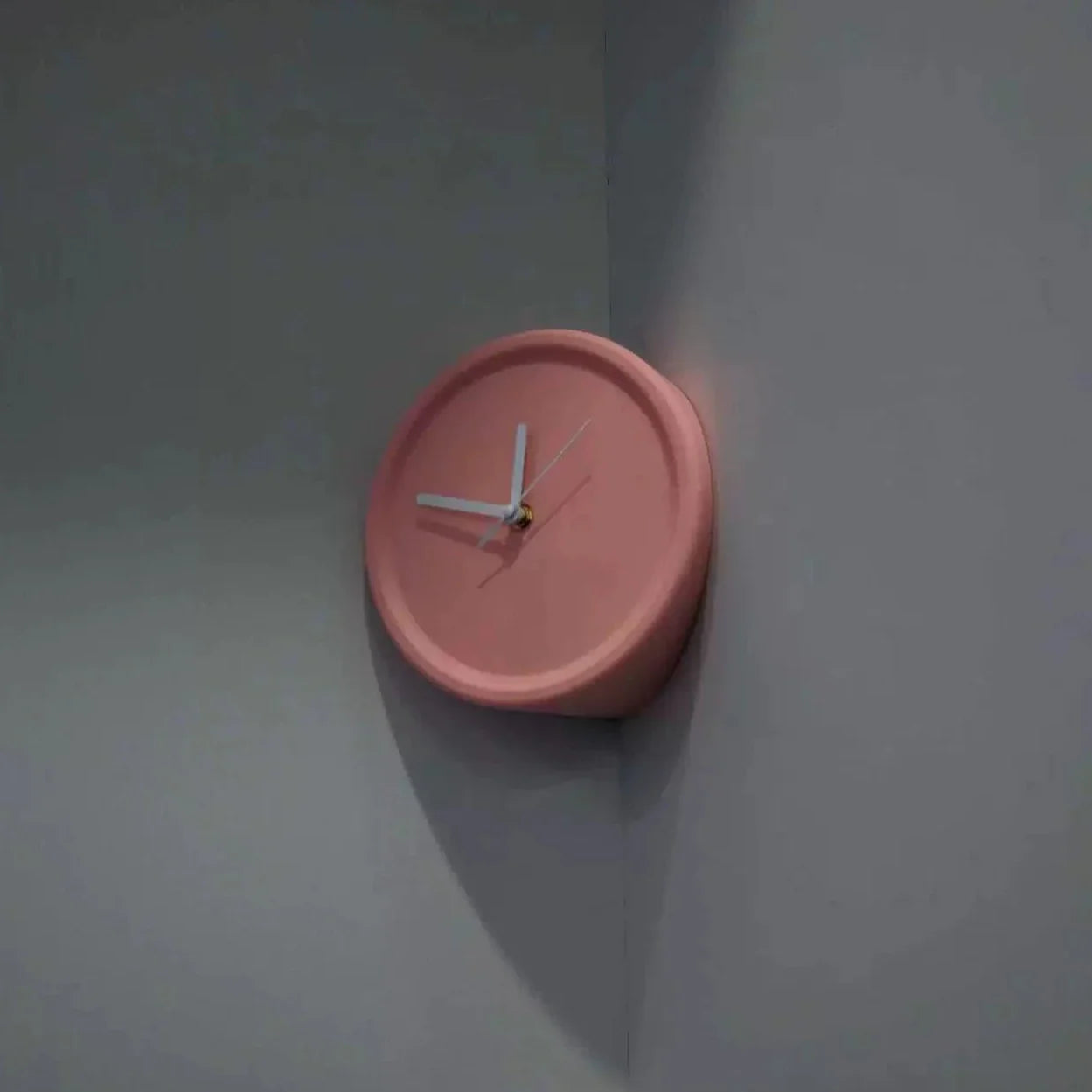Pink wall clock on a plain wall