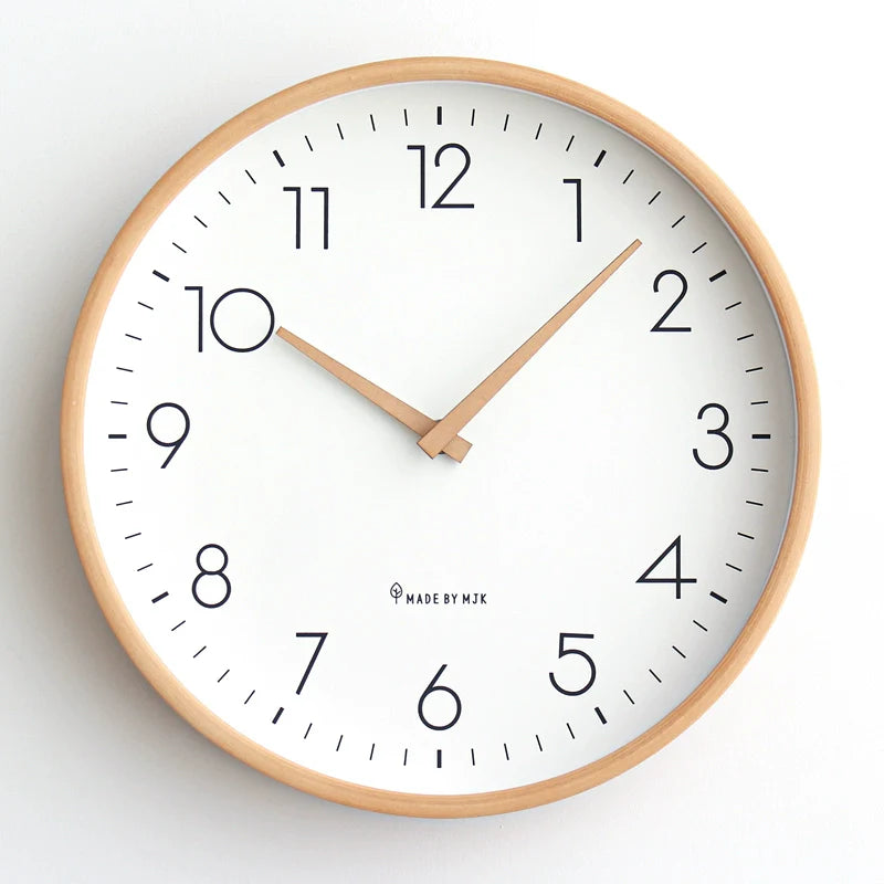 Wall clock with wooden frame and white face on a light gray background