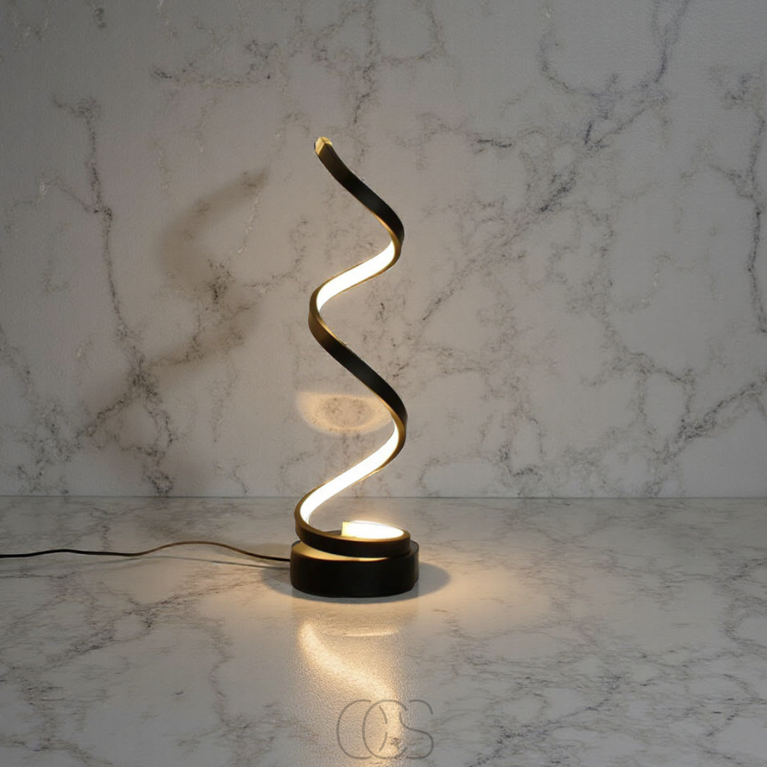 Modern table lamp with a wavy design on a marble surface