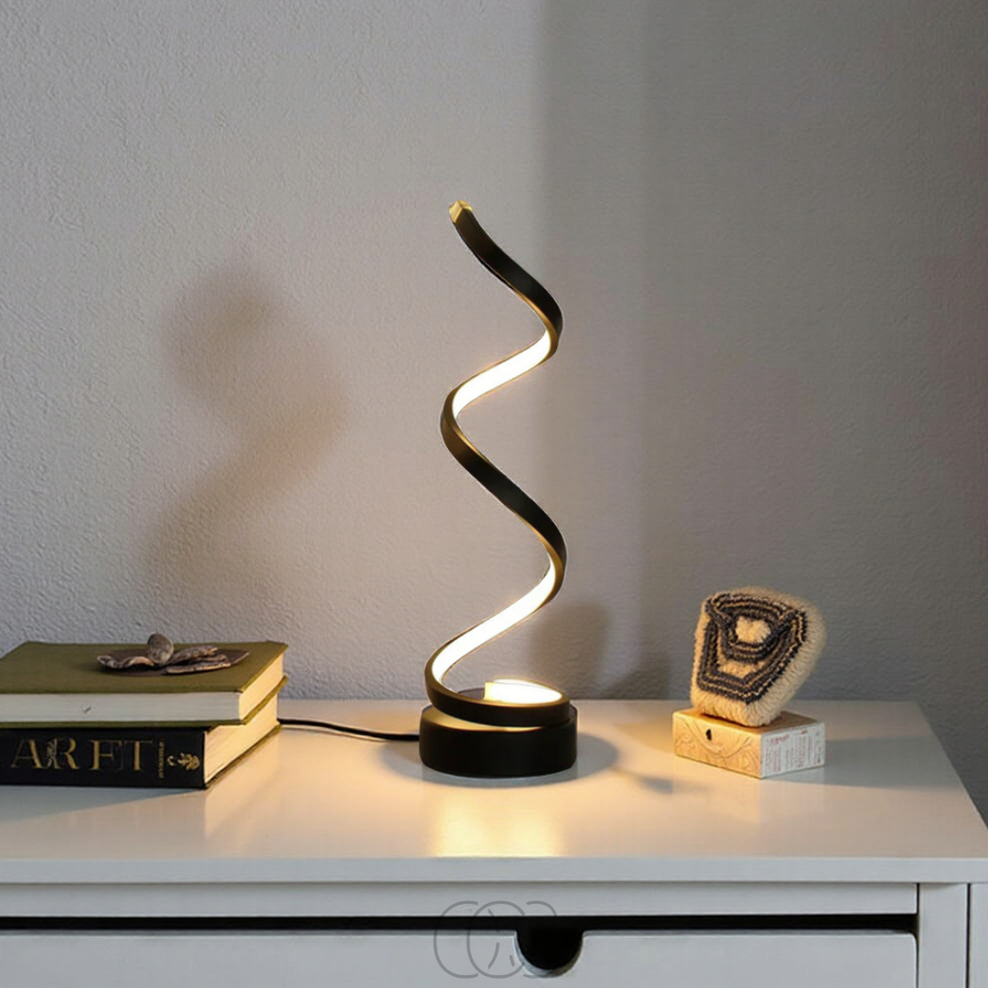Modern table lamp with a wavy design on a white surface.