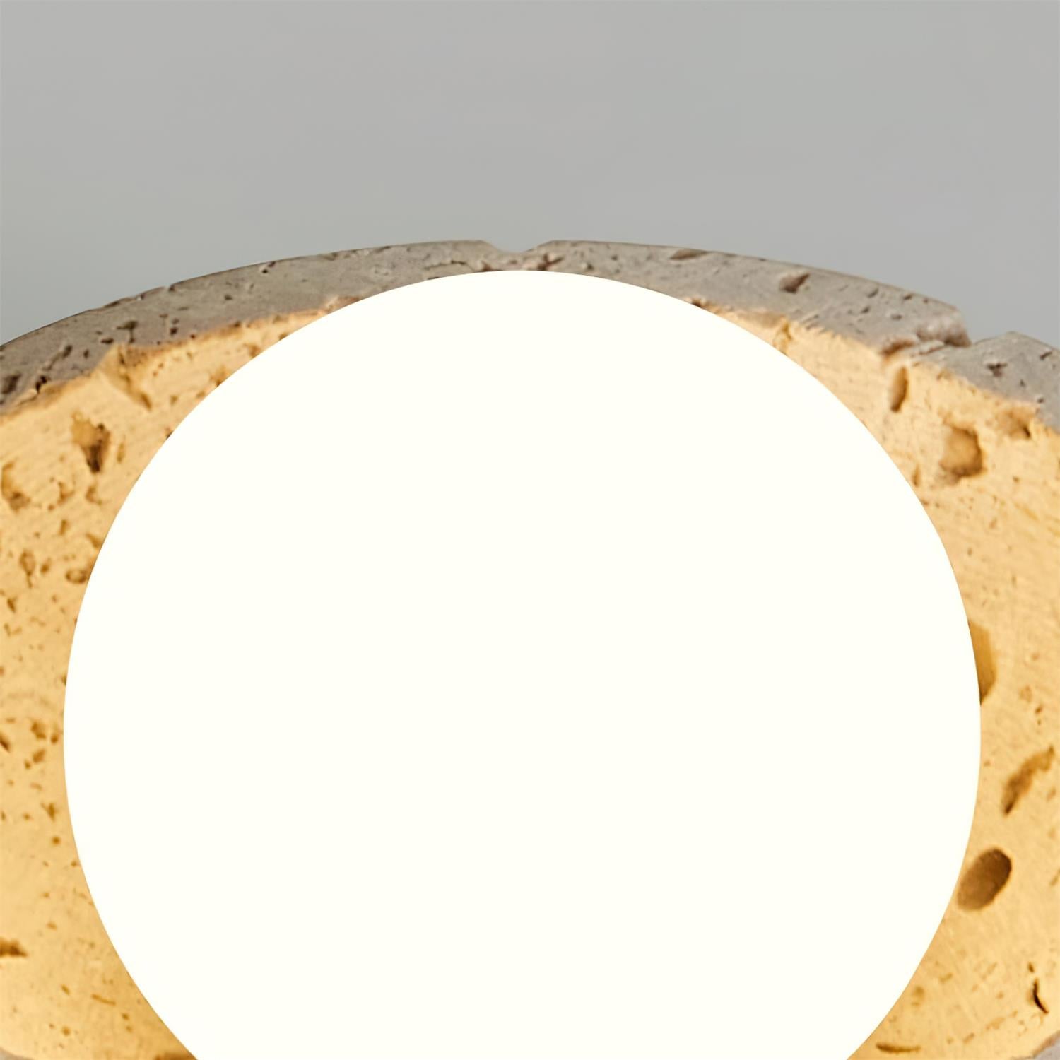 Close-up of a circular stone object with a smooth center on a gray background