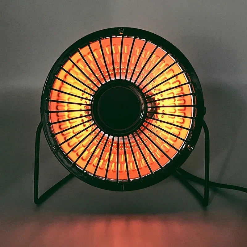 Round electric heater with glowing elements on a gray background