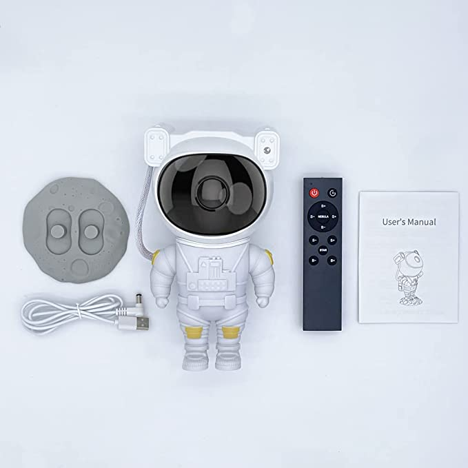 Spaceman-shaped camera with remote control, cable, and user manual on a light gray background