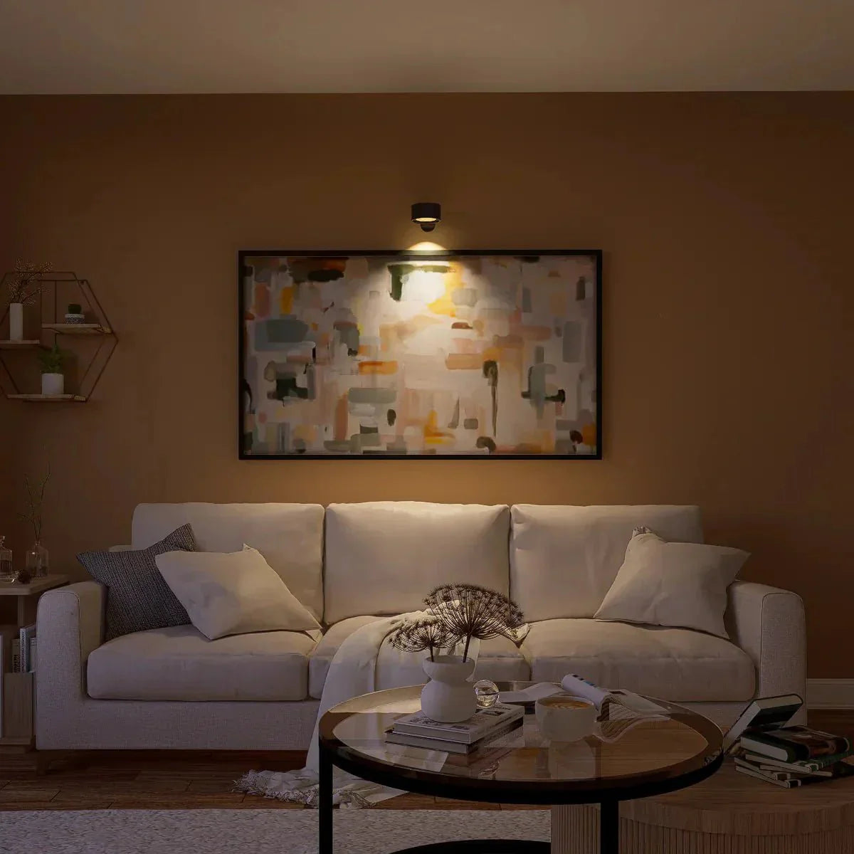 Living room with a white sofa, coffee table, and abstract wall art.