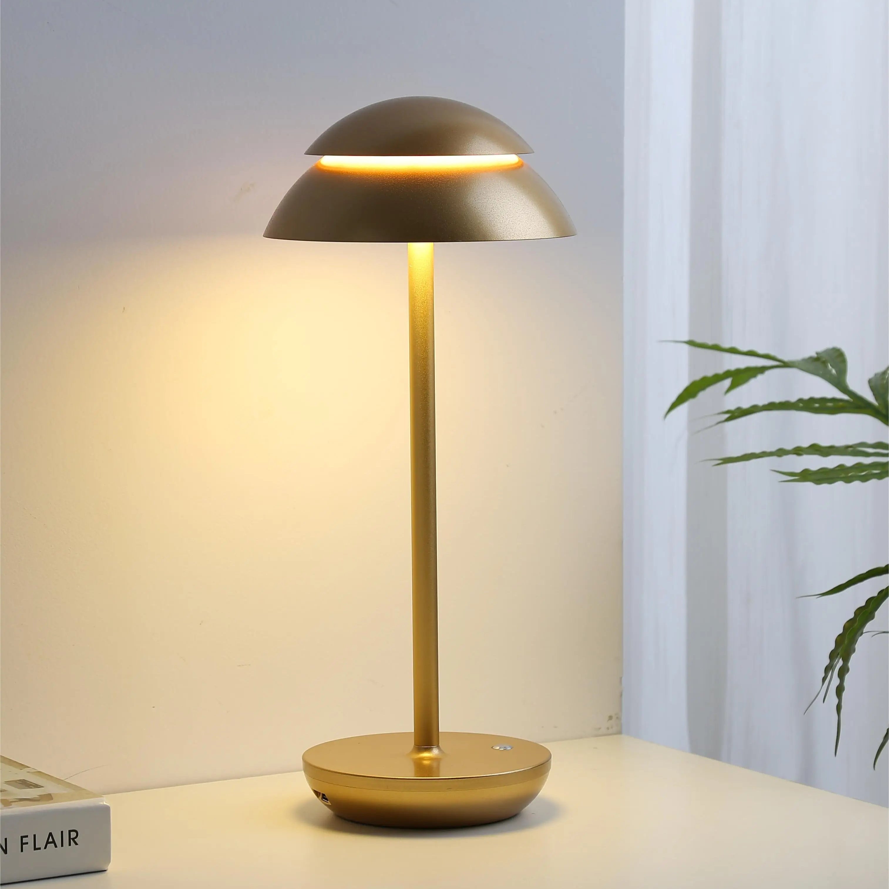 Gold table lamp on a surface with a soft background