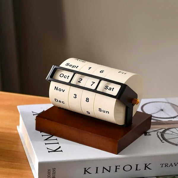 Perpetual calendar on a stack of books with a blurred background