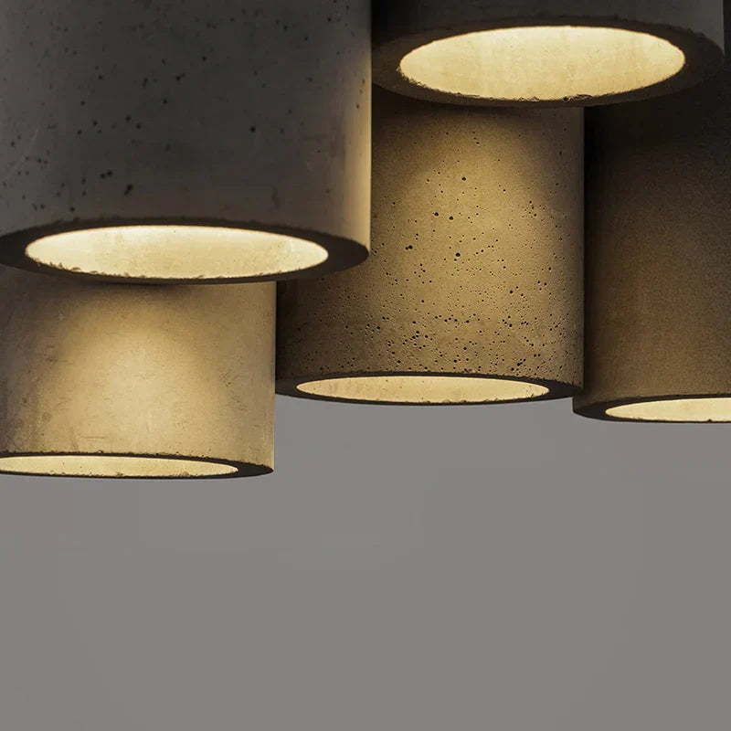 Cylindrical concrete lamps with a textured surface on a gray background