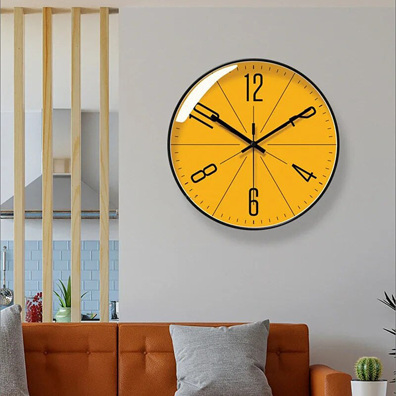 Yellow wall clock on a white wall above an orange sofa.